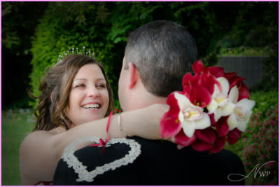 Bride hugs new husband in Berkshire hotel garden